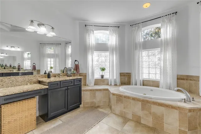 a kitchen with granite countertop a refrigerator stove and cabinets