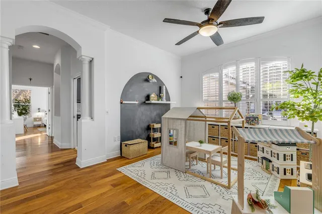 a living room with furniture a window and wooden floor