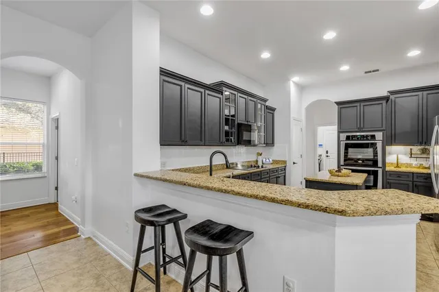 an aerial view of a house with a yard and trees