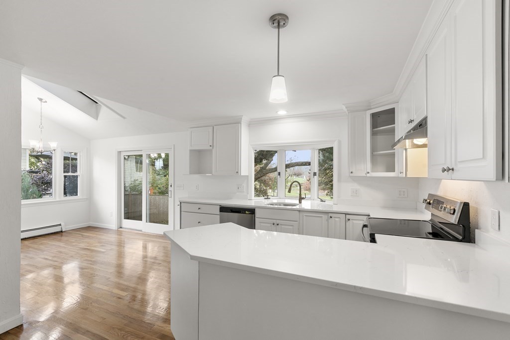 59 Overlook Road Marblehead, MA 01945 - Photo 4 of 16 a large kitchen with kitchen island a counter space a sink a window and stainless steel appliances