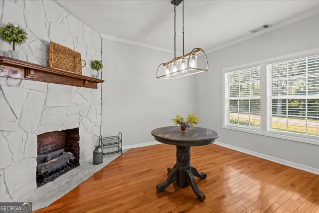 a view of a livingroom with furniture wooden floor and a chandelier