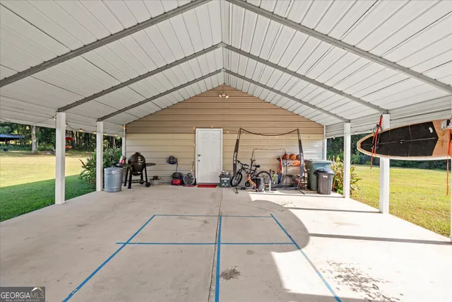 a view of a patio with table and chairs under an umbrella