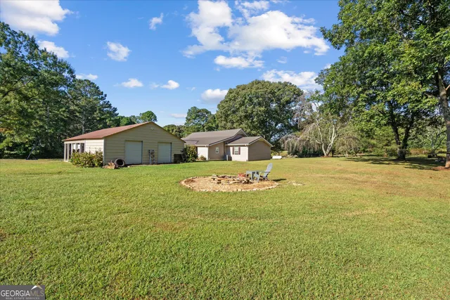 a front view of house with yard and trees