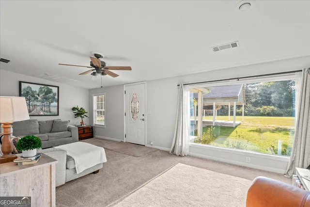 a living room with furniture and a large window