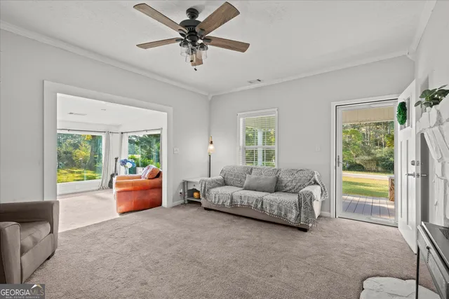 a living room with furniture and a large window