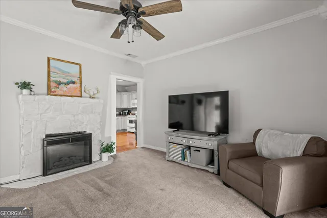 a living room with furniture and a flat screen tv