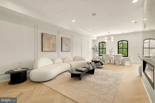 a dining room with furniture a chandelier and window