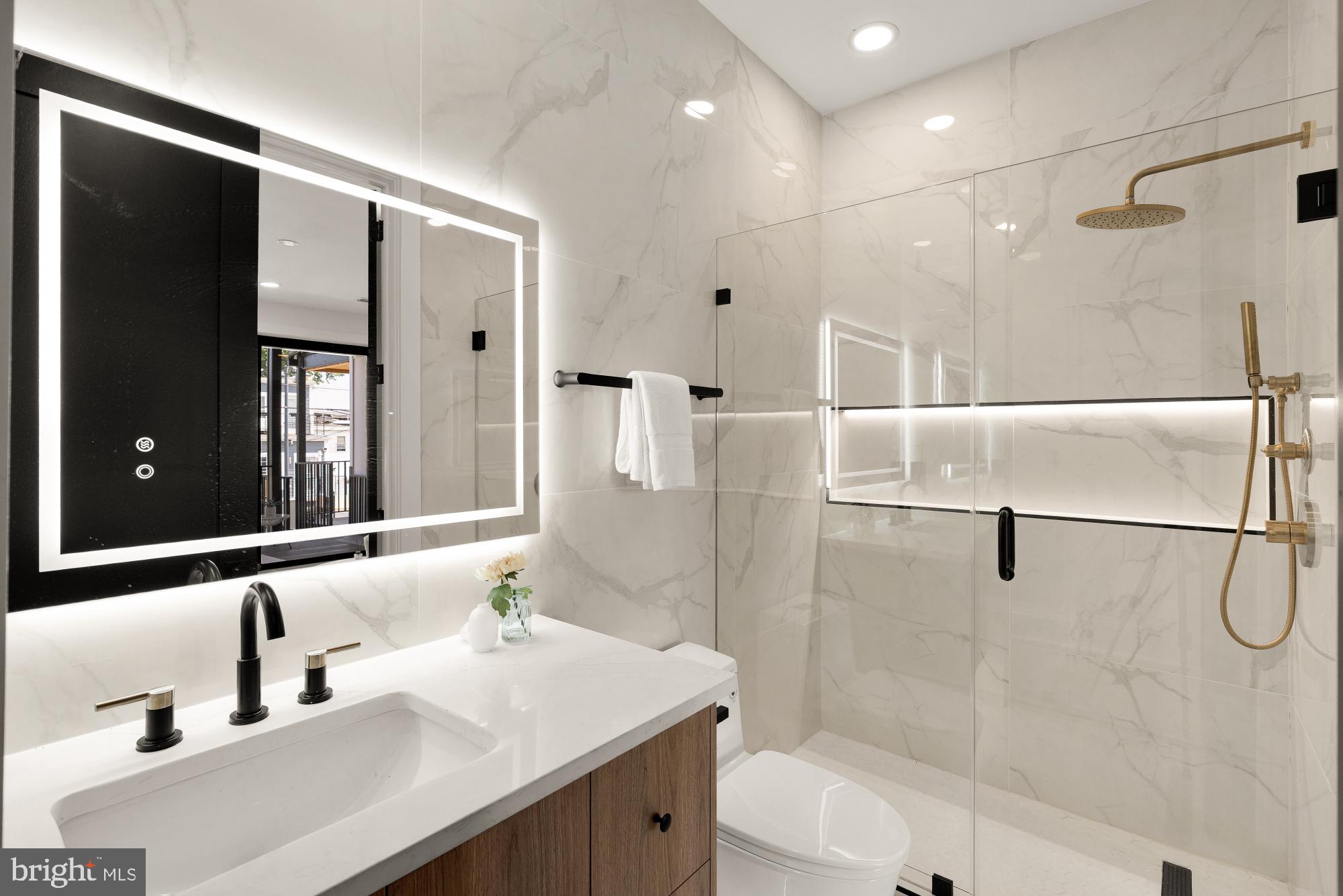 733 Euclid Street Northwest, Unit 302 Washington, DC 20001 - Photo 17 of 55 a bathroom with a tub sink and mirror