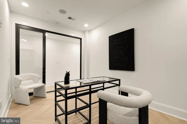 a living room with furniture and large window