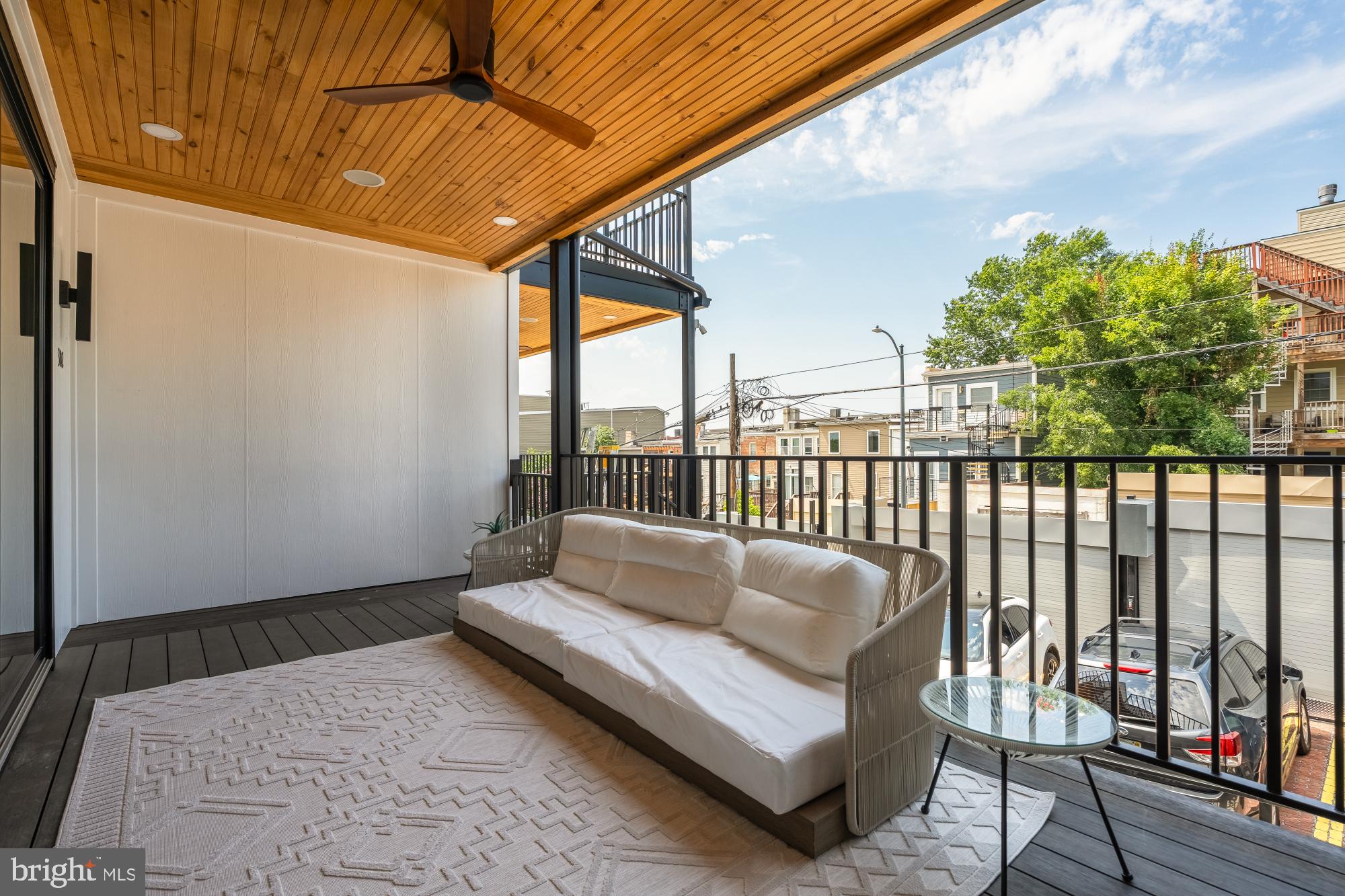 733 Euclid Street Northwest, Unit 302 Washington, DC 20001 - Photo 23 of 55 a balcony with wooden floor and outdoor seating