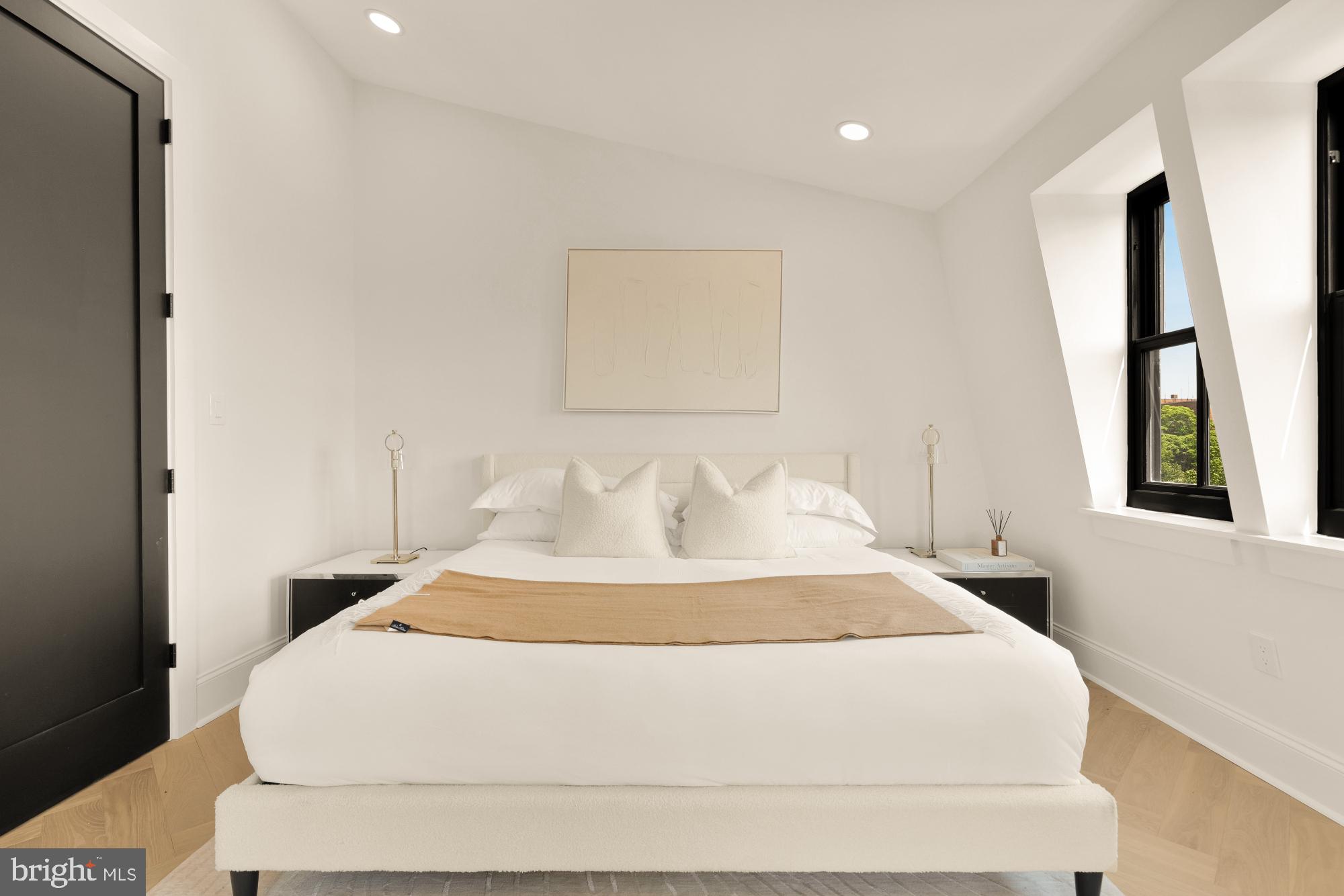 733 Euclid Street Northwest, Unit 302 Washington, DC 20001 - Photo 27 of 55 a large white bed in a white room