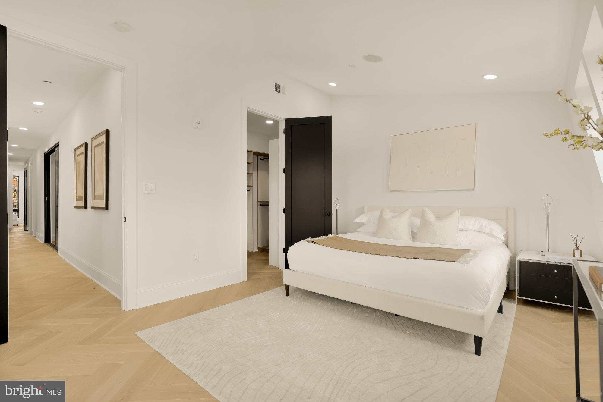 733 Euclid Street Northwest, Unit 302 Washington, DC 20001 - Photo 28 of 55 a bedroom with a bed and a refrigerator