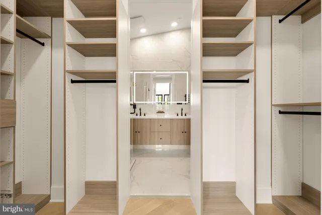 a bathroom with a granite countertop toilet sink and mirror