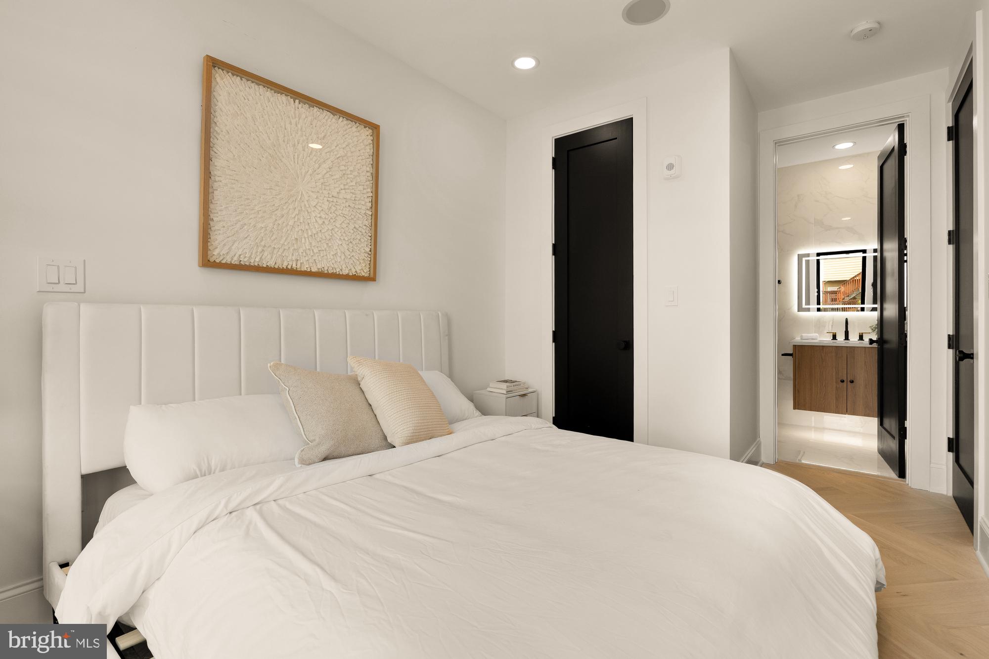 733 Euclid Street Northwest, Unit 302 Washington, DC 20001 - Photo 44 of 55 a bedroom with a bed and a painting