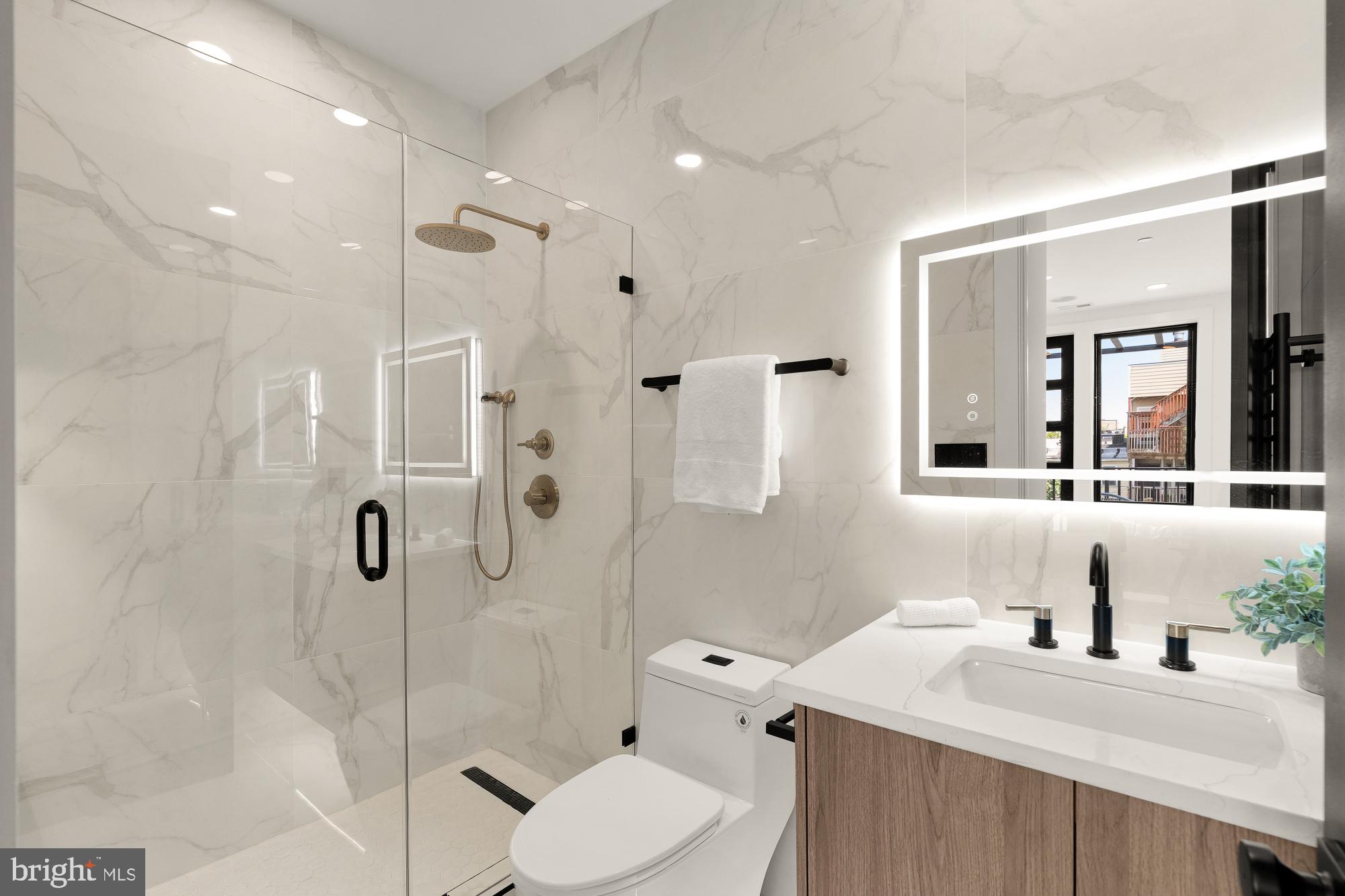 733 Euclid Street Northwest, Unit 302 Washington, DC 20001 - Photo 45 of 55 a bathroom with a sink toilet vanity and shower