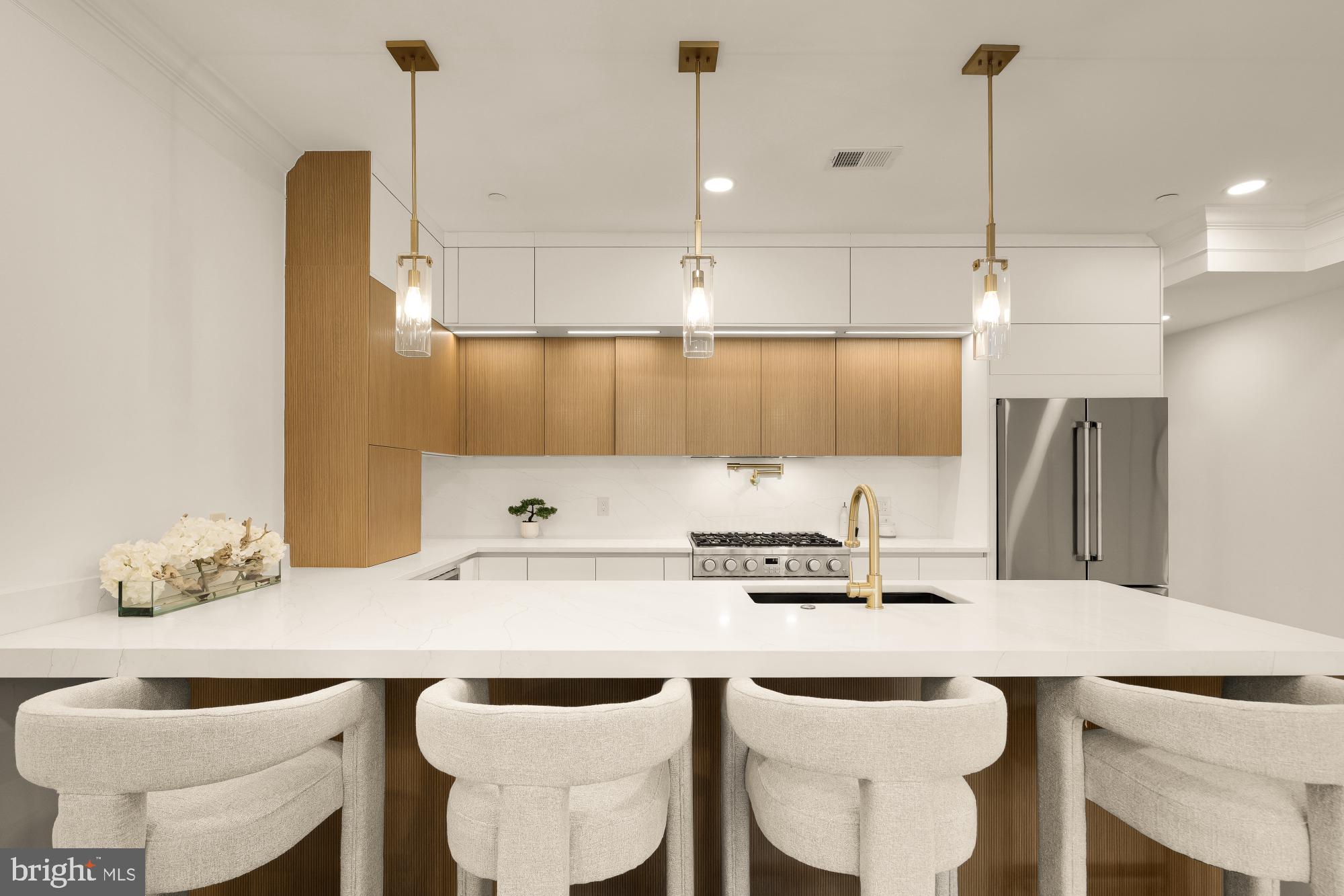 733 Euclid Street Northwest, Unit 302 Washington, DC 20001 - Photo 6 of 55 a kitchen with a sink and chairs