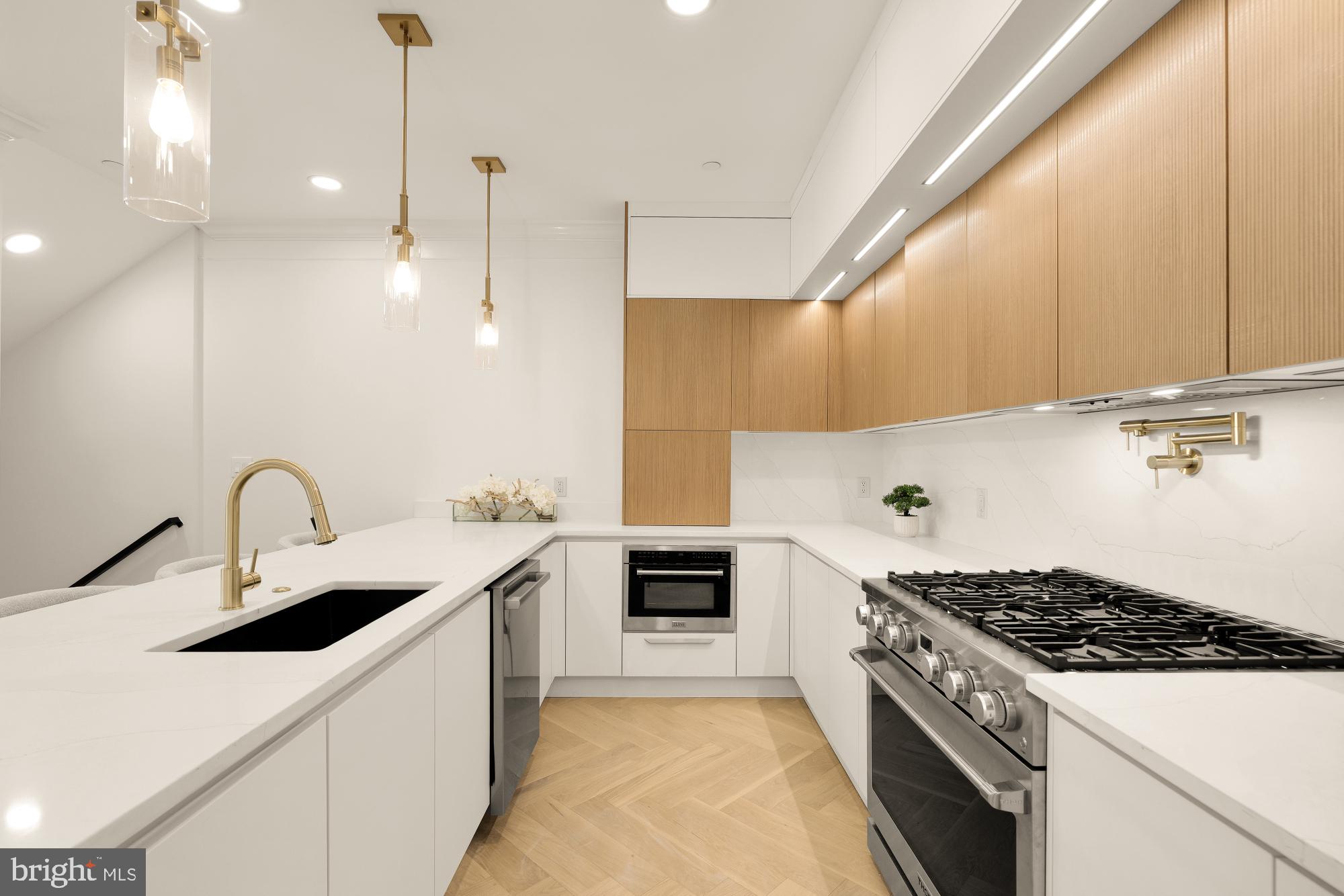 733 Euclid Street Northwest, Unit 302 Washington, DC 20001 - Photo 8 of 55 a kitchen with a sink a stove and cabinets