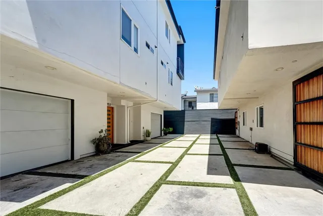 a living room with furniture a flat screen tv and a large window