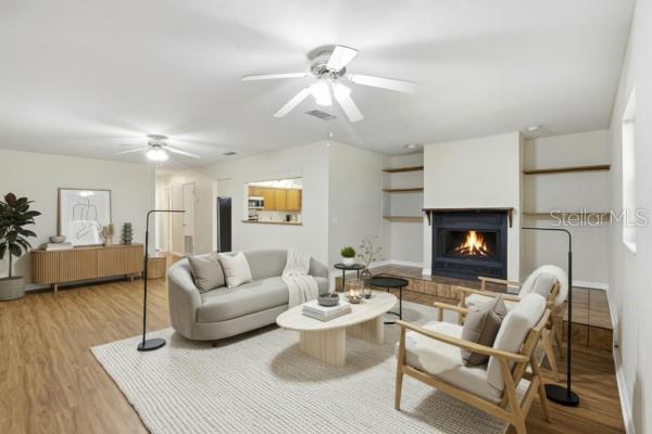 24214 Northwest 52nd Terrace Alachua, FL 32615 - Photo 12 of 22 a living room with furniture and a fireplace