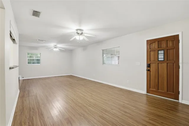 wooden floor in an empty room with a window