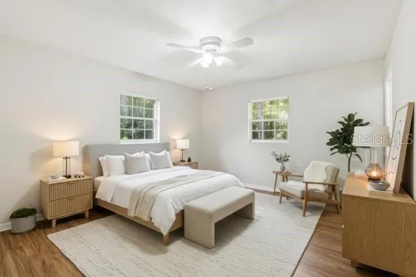 a bedroom with a large bed and a chandelier
