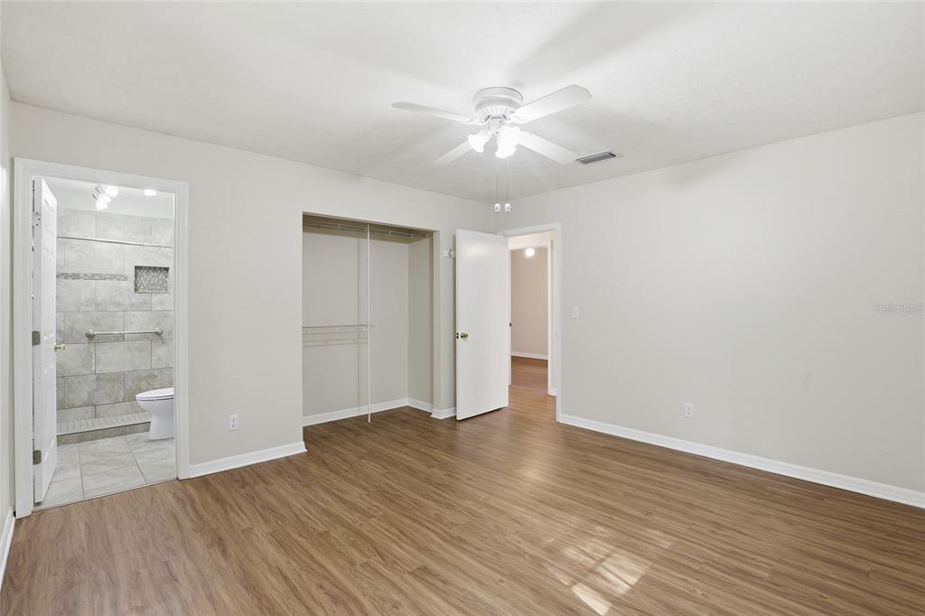 24214 Northwest 52nd Terrace Alachua, FL 32615 - Photo 17 of 22 wooden floor in an empty room with a window