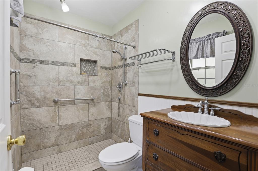 24214 Northwest 52nd Terrace Alachua, FL 32615 - Photo 21 of 22 a bathroom with a sink a toilet and a mirror