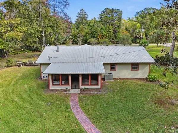 aerial view of a house with a yard table and chairs