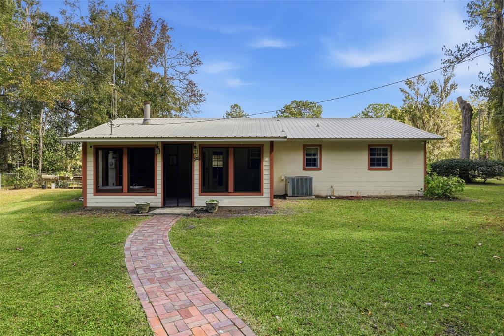 24214 Northwest 52nd Terrace Alachua, FL 32615 - Photo 6 of 22 front view of a house with a yard
