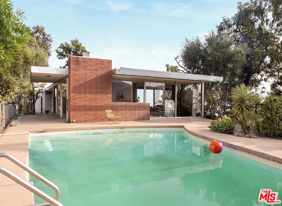 a view of a house with a yard porch and sitting area