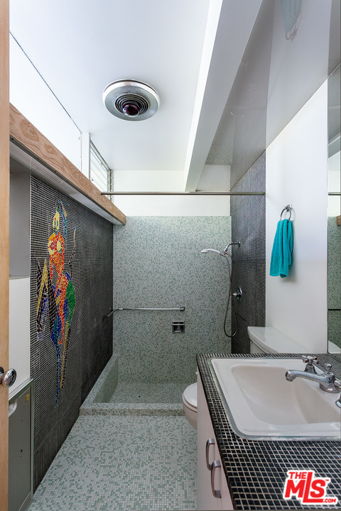 1531 North Tigertail Road Los Angeles, CA 90049 - Photo 17 of 27 a bathroom with a tub and a shower