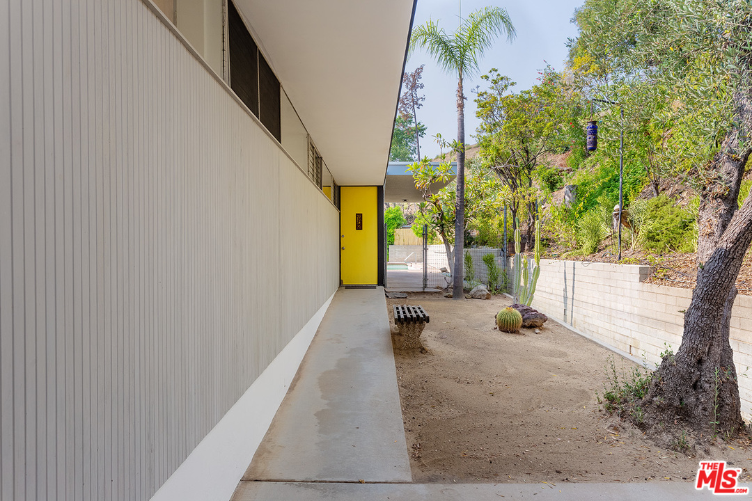 1531 North Tigertail Road Los Angeles, CA 90049 - Photo 3 of 27 a view of a porch with couches and wooden fence