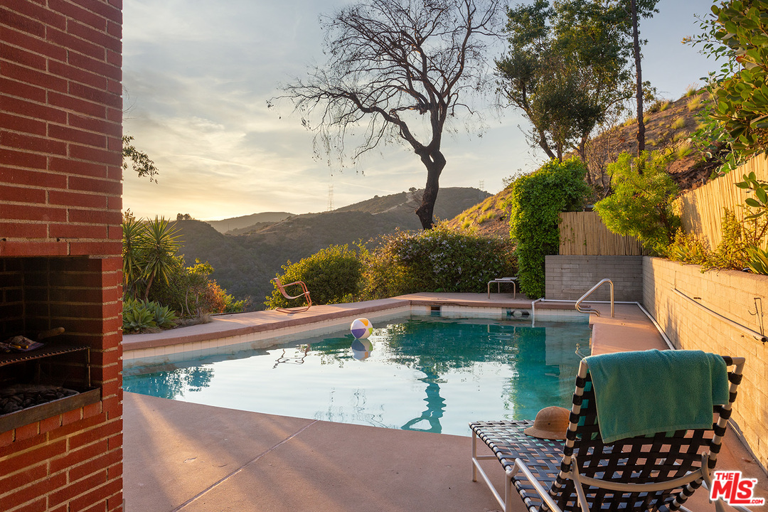 1531 North Tigertail Road Los Angeles, CA 90049 - Photo 22 of 27 a view of a swimming pool with a patio