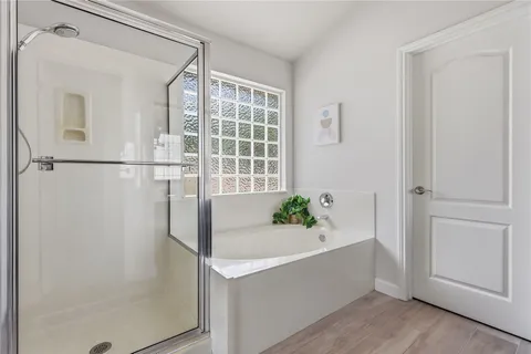 a bathroom with a bathtub and shower