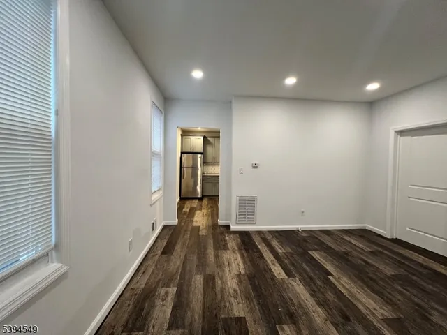 a view of wooden floor in an empty room