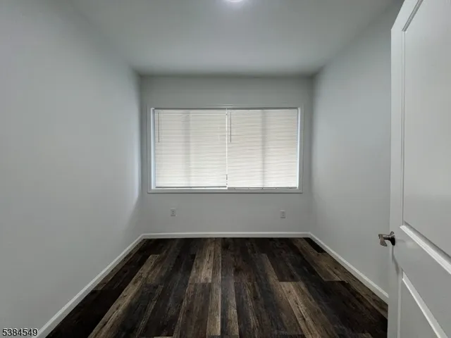 an empty room with wooden floor
