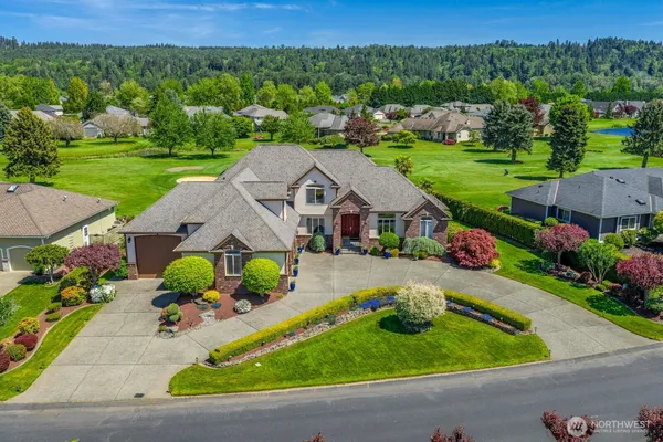 an aerial view of a house with garden space and street view