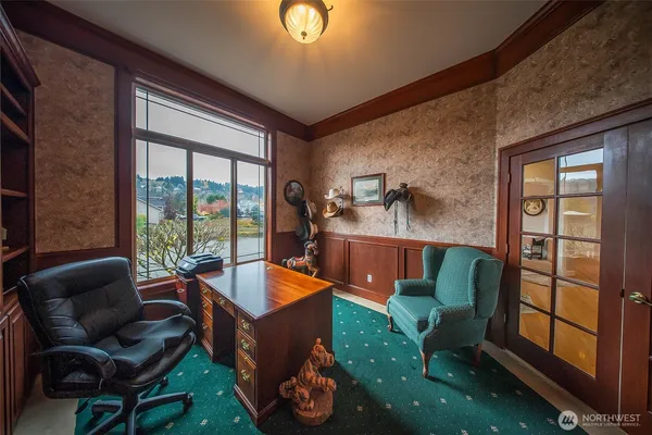 a living room with furniture and a floor to ceiling window