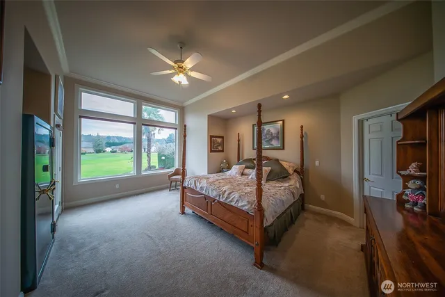 a bed room with a bed and a large window