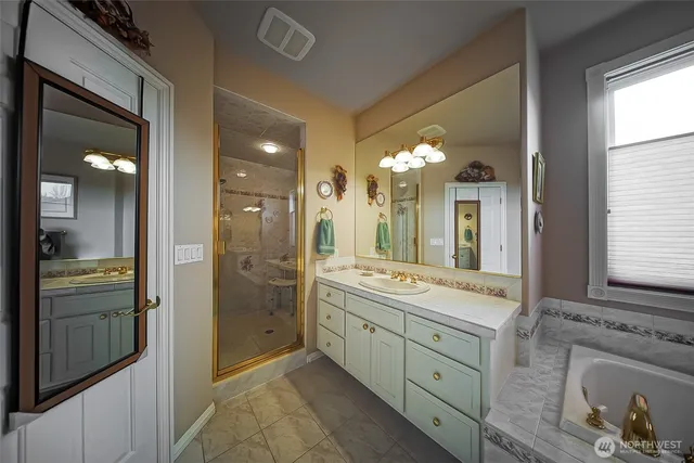 a bathroom with a double vanity sink and a mirror