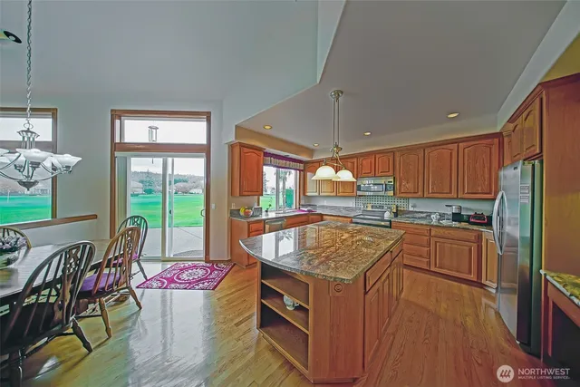 a kitchen with a stove a sink and a refrigerator