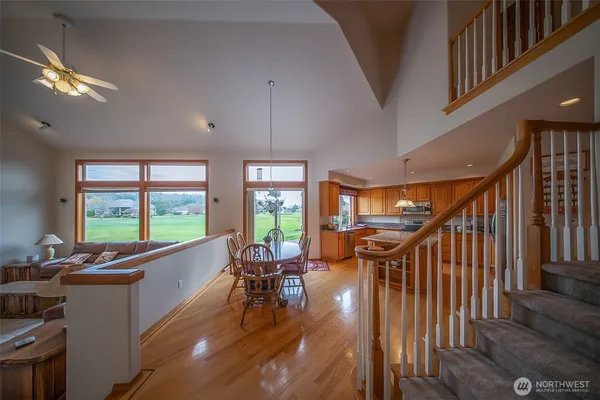 a livingroom with furniture staircase and a kitchen