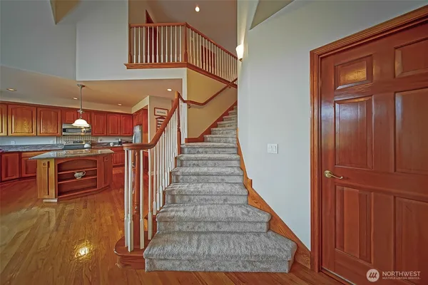 a view of entryway and hall with wooden floor