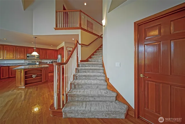 a view of entryway and hall with wooden floor