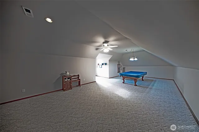 a view of a livingroom with furniture and chandelier fan