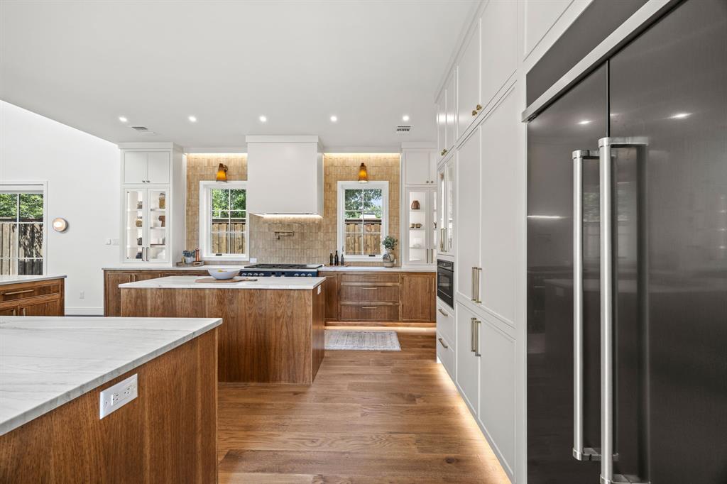 4557 Ridge Road Dallas, TX 75229 - Photo 11 of 37 a kitchen with stainless steel appliances granite countertop a refrigerator a sink dishwasher and a oven with wooden floor