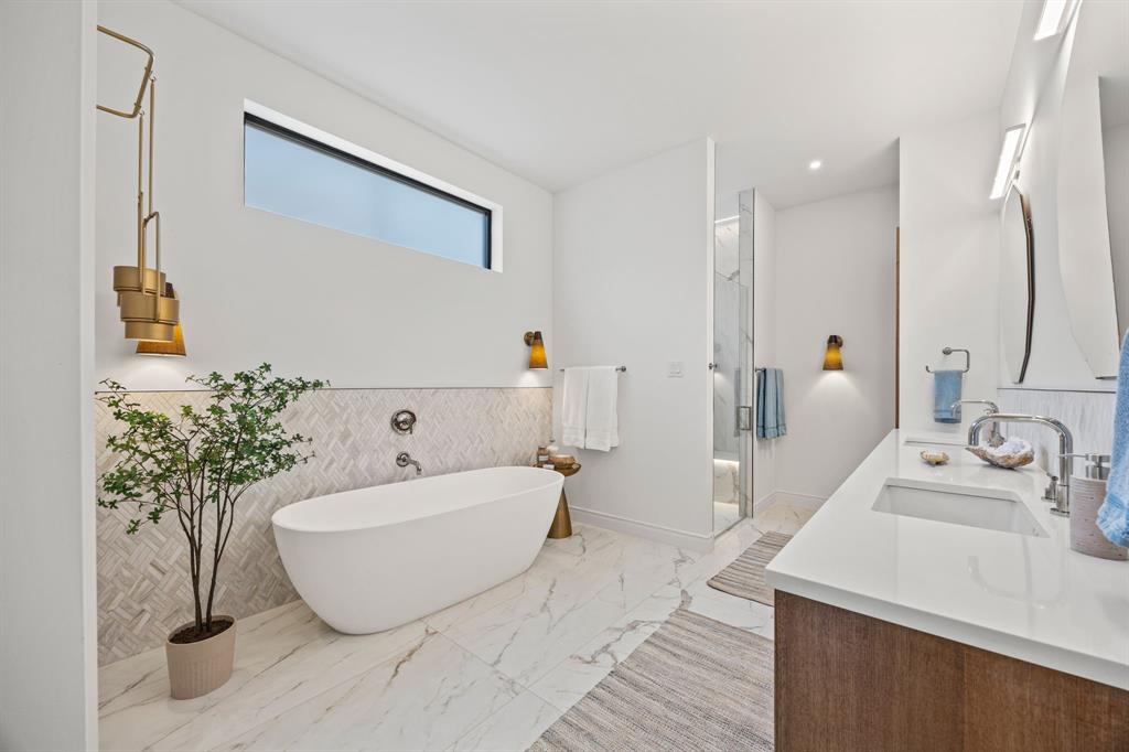 4557 Ridge Road Dallas, TX 75229 - Photo 18 of 37 a bathroom with a bathtub and a sink