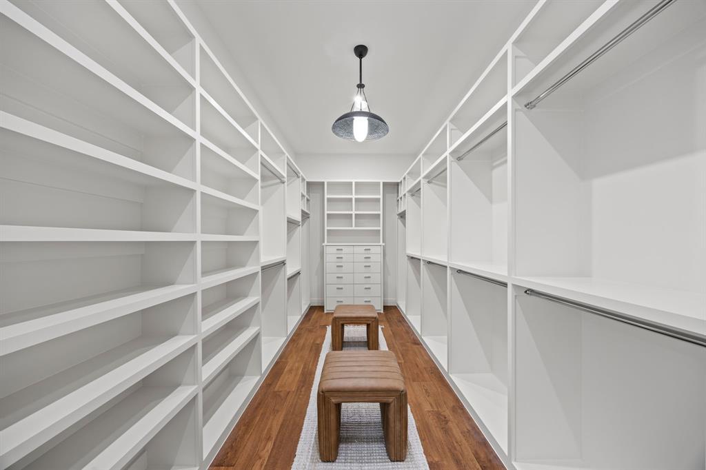 4557 Ridge Road Dallas, TX 75229 - Photo 19 of 37 a view of a hallway with wooden floor and staircase