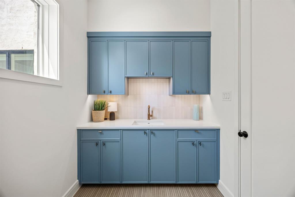 4557 Ridge Road Dallas, TX 75229 - Photo 22 of 37 a kitchen with a sink cabinets and a window