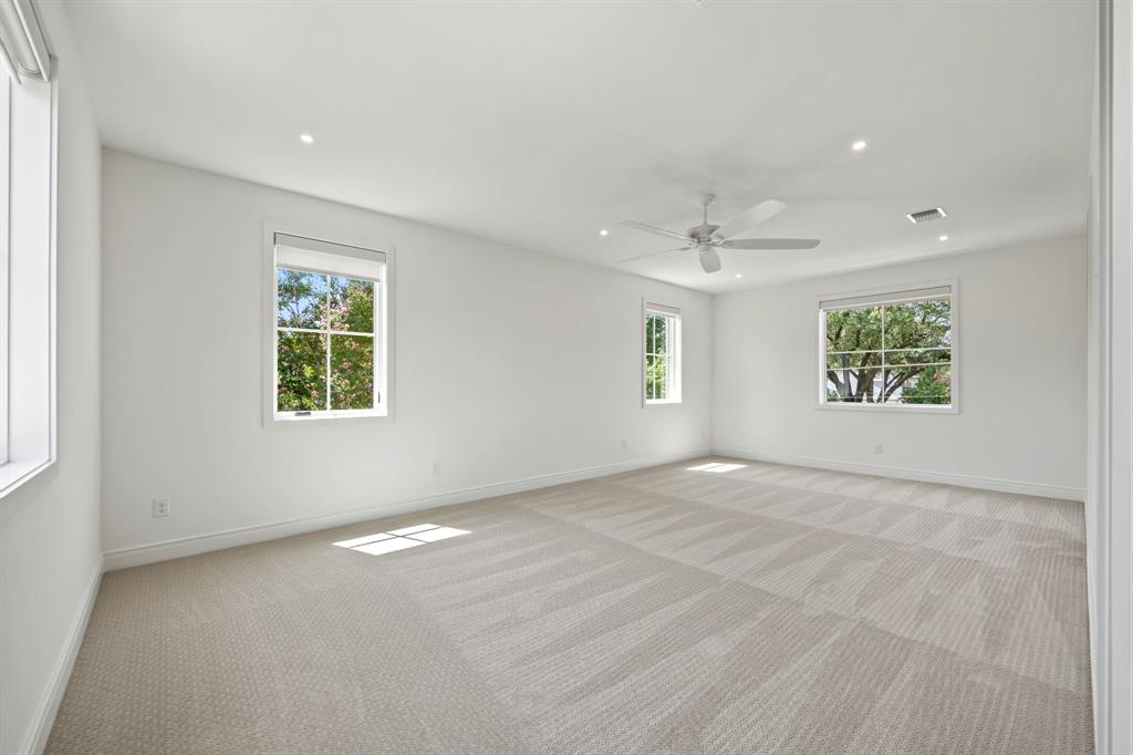 4557 Ridge Road Dallas, TX 75229 - Photo 34 of 37 an empty room with windows and a ceiling fan